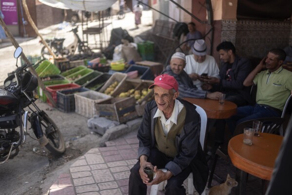 People displaced by the earthquake gather at a coffee shop and drink tea, in Amizmiz, outside Marrakech, Friday, Oct. 6, 2023. Villagers in hard-hit regions are weighing how to best rebuild as Moroccan authorities begin to providing rehousing funds to those whose homes were destroyed by last month's earthquake. (AP Photo/Mosa'ab Elshamy)