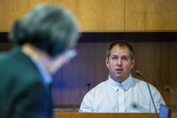American Matthew Urey is seen in the witness box at the Whakaari White Island eruption trial at the Auckland Environment Court, in Auckland, New Zealand, Wednesday, July 12, 2023. Urey, 39, and his wife Lauren Urey, 35, returned to New Zealand from their home in Richmond, Virginia, to testify in the Auckland District Court on Wednesday in the trial of three tourism companies and three directors charged with safety breaches over the White Island disaster on Dec. 9. 2019. (Jason Oxenham, Pool Photo via AP)