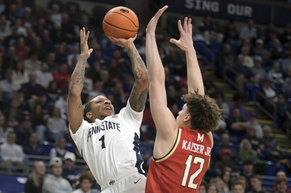 Penn State's Ace Baldwin Jr. (1) shoos over Maryland's Jamie Kaiser Jr. (12) during the first half of an NCAA college basketball game Sunday, March 10, 2024, in State College, Pa. (AP Photo/Gary M. Baranec)