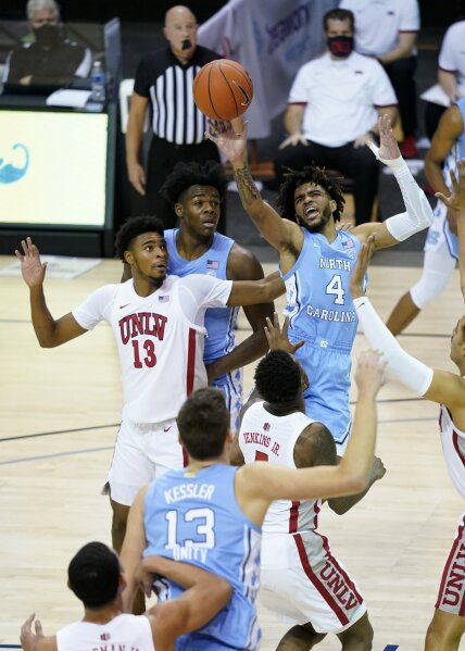 North Carolina guard R.J. Davis (4) leaps to shoot a basket over UNLV guard Bryce Hamilton (13) in the first half of an NCAA college basketball game in the Maui Invitational tournament, Monday, Nov. 30, 2020, in Asheville, N.C. (AP Photo/Kathy Kmonicek)