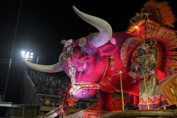 A performer from the Unidos de Padre Miguel samba school dances on a float during Carnival celebrations at the Sambadrome in Rio de Janeiro, Sunday, March 2, 2025. (AP Photo/Silvia Izquierdo)