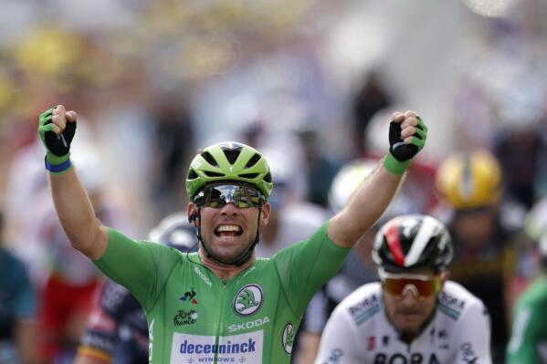 Britain's Mark Cavendish, wearing the best sprinter's green, celebrates as he crosses the finish line to win the sixth stage of the Tour de France cycling race over 160.6 kilometers (99.8 miles) with start in Tours and finish in Chateauroux, France, Thursday, July 1, 2021. (Stephane Mahe, Pool Photo via AP)