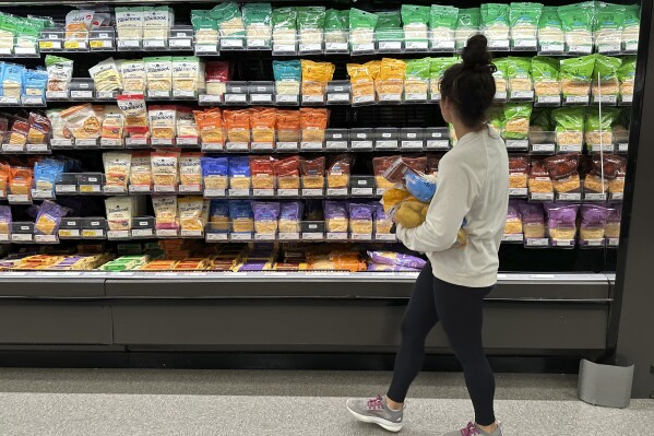 A shopper peruses cheese offerings at a Target store Wednesday, Oct. 4, 2023, in Sheridan, Colo. On Thursday, the Labor Department issues its report on inflation at the consumer level. (AP Photo/David Zalubowski)