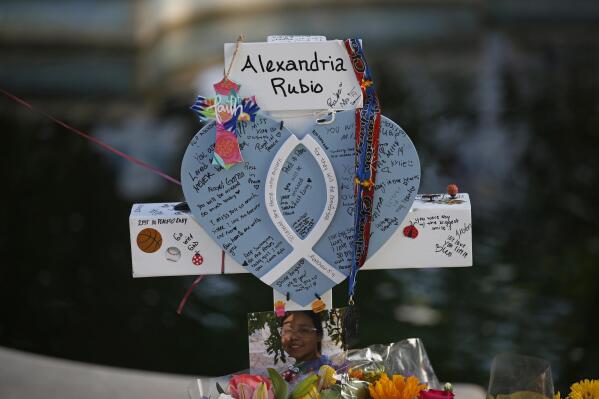 Alexandria Rubio's cross stands at a memorial site for the victims killed in this week's shooting at Robb Elementary School in Uvalde, Texas, Friday, May 27, 2022. (AP Photo/Dario Lopez-Mills)