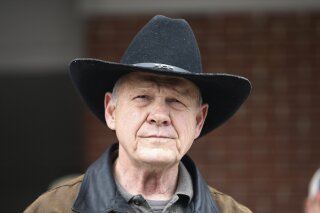 FILE - In this Dec. 12, 2017, file photo, Roy Moore speaks to the media after he rode in on a horse to vote in Gallant, Ala. Moore says he’s considering a fresh run for Senate in 2020. That’s prompting national Republican leaders to signal that they’d try again to prevent their party from nominating Moore, who’s denied long-ago sexual impropriety with teenagers. (AP Photo/Brynn Anderson, File)