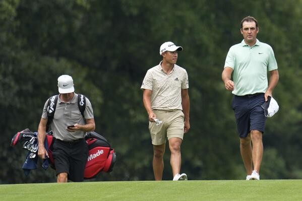 Scottie Scheffler, right, and Collin Morikawa, second from right, walk to their balls on the 14th fairway during a practice round for the PGA TOUR Championship at East Lake Golf Club Wednesday Aug 24, 2022, in Atlanta, Ga. (AP Photo/Steve Helber)