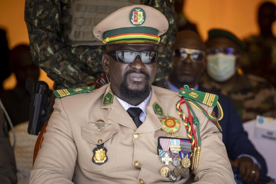 FILE - Guinea's junta leader Col. Mamady Doumbouya watches over an independence day military parade in Bamako, Mali on Sept. 22, 2022. The government led by Guinea's coup leader reached an agreement late Friday, Oct. 21, 2022 with West African regional mediators on a schedule for holding new elections a little over two years from now. (AP Photo, File)