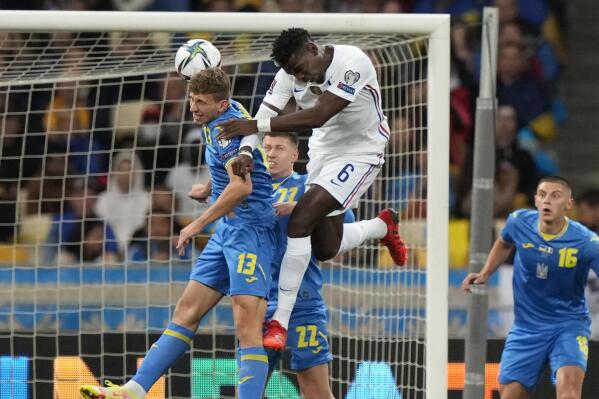 Ukraine's Ilya Zabarnyi, left, challenges for the ball with France's Paul Pogba during the World Cup 2022 group D qualifying soccer match between Ukraine and France at the Olimpiyskiy Stadium in Kyiv, Ukraine, Saturday, Sept. 4, 2021. (AP Photo/Efrem Lukatsky)