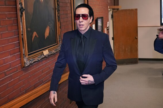 Musical artist Marilyn Manson, whose legal name is Brian Hugh Warner, leaves after appearing in Belknap Superior Court,Monday, Sept. 18, 2023, in Laconia, N.H. Manson, who was charged with charged with two misdemeanor counts of simple assault, was accused of approaching a videographer at his 2019 concert in New Hampshire and allegedly spitting and blowing his nose on her. (AP Photo/Charles Krupa)