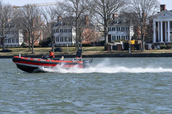 In this Friday March 19, 2021, photo a District of Columbia Fire Boat checks buoys in the waterway next to Fort McNair, seen in background in Washington. Iran has made threats against Fort McNair, a U.S. army base in Washington DC, and against the Army’s vice chief of staff, according to two senior U.S. intelligence officials, who spoke on condition of anonymity to discuss national security matters. The threats are one reason the Army has been pushing for more security around the base, which sits alongside the bustling Waterfront district of Washington DC. (AP Photo/Jacquelyn Martin)