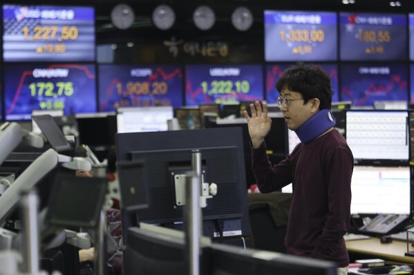 A currency trader gestures at the foreign exchange dealing room of the KEB Hana Bank headquarters in Seoul, South Korea, Friday, April 17, 2020. Shares have advanced in Asia after China's economic growth data, while bleak, was better than expected. (AP Photo/Ahn Young-joon)