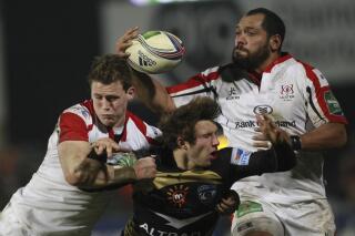 FILE - Ulster's John Afoa, right, and Craig Gilroy, left, hold off a tackle from Montpellier's Yohan Artru, center, during their Rugby Union European Cup Round 5 match at Ravenhill Stadium, Belfast, Northern Ireland, on Jan. 10, 2014. A lesser team than the Christchurch-based Crusaders might have been laid low by the barrage of injuries and other setbacks which have dogged the latter part of the regular season in Super Rugby Pacific. (AP Photo/Peter Morrison, File)