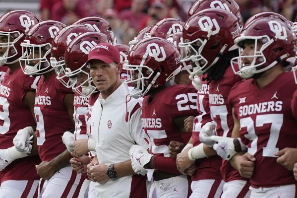 Oklahoma head coach Brent Venables and players link arms across the field before an NCAA college football game against Kent State, Saturday, Sept. 10, 2022, in Norman, Okla. (AP Photo/Sue Ogrocki)