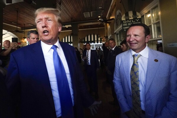 FILE - Former President Donald Trump, left, and Louisiana Attorney General Jeff Landry visit Café du Monde in New Orleans, July 25, 2023. Louisiana politics has been dominated so far this year by new Republican Gov. Jeff Landry's special legislative sessions to address crime and adopt new congressional maps, but the focus will shift briefly Saturday, March 23, 2024, to the state's presidential primaries. President Joe Biden and Trump both unofficially sewed up their parties' nominations last week and face little opposition on Louisiana's primary ballot. (AP Photo/Gerald Herbert, File)