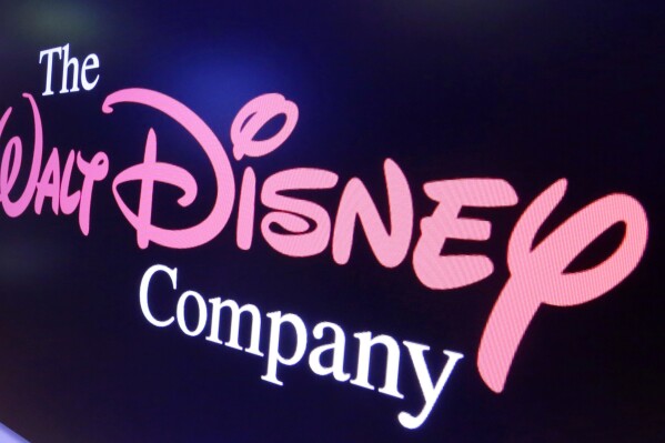 FILE - The Walt Disney Co. logo appears on a screen above the floor of the New York Stock Exchange, Aug. 7, 2017, in New York. The Walt Disney Co. on Monday, Nov. 6, 2023 named 34-year PepsiCo veteran Hugh Johnston as its new chief financial officer. Johnston, who has been PepsiCo’s CFO since 2010, will replace Kevin Lansberry effective Dec. 4. Lansberry was appointed Disney’s interim CFO earlier this year. (AP Photo/Richard Drew, File)