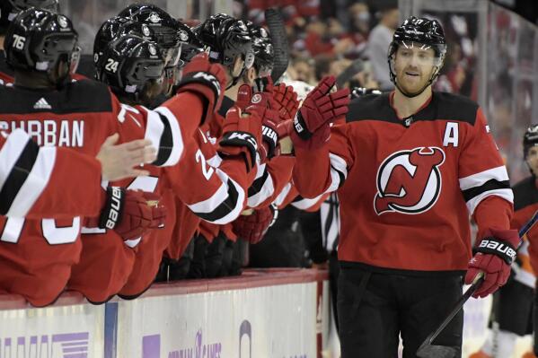 New Jersey Devils defenseman Dougie Hamilton, right, celebrates his goal with teammates during the first period of an NHL hockey game against the Philadelphia Flyers Sunday, Nov. 28, 2021, in Newark, N.J. (AP Photo/Bill Kostroun)