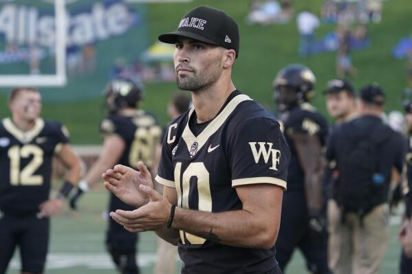 Injured Wake Forest quarterback Sam Hartman (10) watches teammates warm up for an NCAA college football game against VMI in Winston-Salem, N.C., Thursday, Sept. 1, 2022. (AP Photo/Chuck Burton)