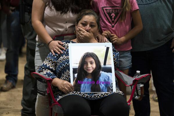Esmeralda Bravo, 63, sheds tears while holding a photo of her granddaughter, Nevaeh, one of the Robb Elementary School shooting victims, during a prayer vigil in Uvalde, Texas, May 25, 2022. The children who survived the attack, which killed 19 schoolchildren and two teachers, described a festive, end-of-the-school-year day that quickly turned to terror.(AP Photo/Jae C. Hong, File)
