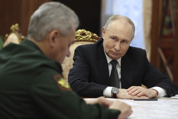 Russian President Vladimir Putin, right, listens to Russian Defense Minister Sergei Shoigu during their meeting at the Kremlin in Moscow, Russia, Tuesday, Feb. 20, 2024. (Alexander Kazakov, Sputnik, Kremlin Pool Photo via AP)