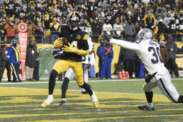 Pittsburgh Steelers wide receiver George Pickens (14) scores during the second half of an NFL football game against the Las Vegas Raiders in Pittsburgh, Saturday, Dec. 24, 2022. (AP Photo/Don Wright)