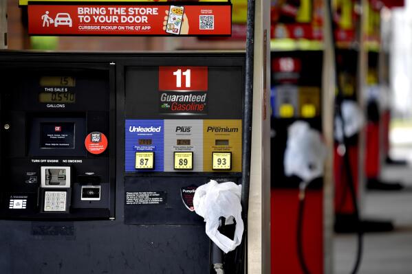 FILE - In this May 11, 2021 file photo, a QuickTrip convenience store has bags on their pumps as the station has no gas, in Kennesaw, Ga. On Friday, May 14, The Associated Press reported on stories circulating online claiming to show photos of Americans filling their cars with plastic bags of gasoline and lining up at gas stations with red gas cans in recent days. Social media users are misrepresenting old photos to falsely suggest they show Americans stockpiling gasoline this week after a hack of the Colonial Pipeline led to thousands of gas stations running out of fuel to due to distribution problems and panic-buying. (AP Photo/Mike Stewart, File)