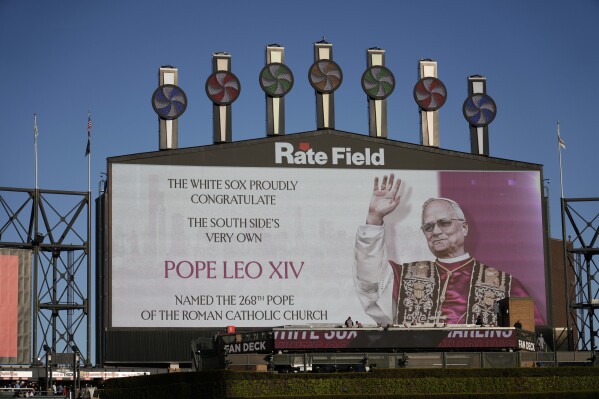 The Chicago White Sox honors Pope Leo XIV on the scoreboard before a baseball game against the Miami Marlins, Friday, May 8, 2025, in Chicago. (AP Photo/David Banks)