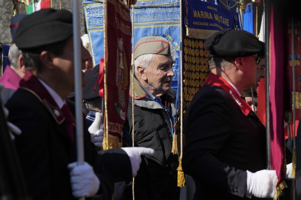 Members of Italian partisan associations attend a commemorative ceremony for the 80th anniversary of the massacre of the Fosse Ardeatine, in Rome, Friday, March 22, 2024. The mass killing of 335 civilians and political prisoners was carried out in this cave area in Rome on 24 March 1944 by German occupation troops during the Second World War as a reprisal for the Via Rasella attack in central Rome against the SS Police Regiment Bozen the previous day. The Ardeatine Caves site was later declared memorial cemetery and a Mausoleum was built in memory of the victims buried there. (AP Photo/Andrew Medichini)