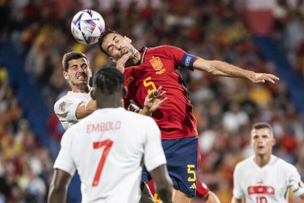 FILE - Swiss Remo Freuler, left, fights for a header with Spain's midfielder Sergio Busquets, during the UEFA Nations League group A2 soccer match between Spain and Switzerland at the Romareda stadium in Zaragoza, Spain, Saturday, Sept. 24, 2022. (Jean-Christophe Bott/Keystone via AP, File)