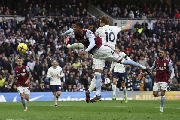 Tottenham's Harry Kane (10) heads past Aston Villa's Ezri Konsa in an attempt to score during the English Premier League soccer match between Tottenham Hotspur and Aston Villa at Tottenham Hotspur Stadium in London, Sunday, Jan. 1, 2023. (AP Photo/Ian Walton)