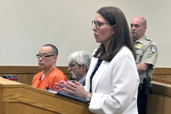 Michigan Assistant Attorney General Shawn Ryan speaks in court in Howell, Mich., on Friday, May 17, 2024. A judge set a trial date for Glenn Chin, seated in orange. He's a pharmacist blamed for 11 deaths linked to contaminated steroids made in 2012 at a Massachusetts specialty lab. (Ǻ Photo/Ed White)