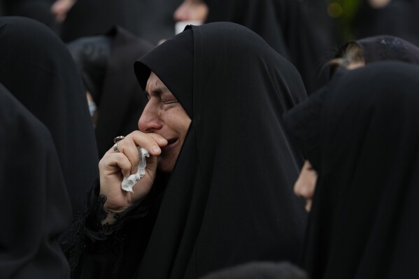 A woman weeps during a mourning ceremony for Iranian President Ebrahim Raisi at Vali-e-Asr square in downtown Tehran, Iran, Monday, May 20, 2024. (AP Photo/Vahid Salemi)