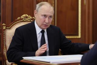 Russian President Vladimir Putin speaks to Vladimir Saldo, the head of the Russian-controlled Kherson region, during their meeting in Moscow, Russia, Thursday, April 6, 2023. (Gavriil Grigorov, Sputnik, Kremlin Pool Photo via AP)