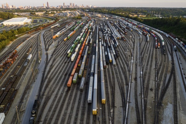 FILE - Freight train cars sit in a Norfolk Southern rail yard on Sept. 14, 2022, in Atlanta. Companies that have plants and facilities only served by one railroad may soon be able to get a bid from another railroad if their current service is bad enough under a new rule that was proposed Thursday, Sept. 7, 2023 to help boost competition. (AP Photo/Danny Karnik, file)