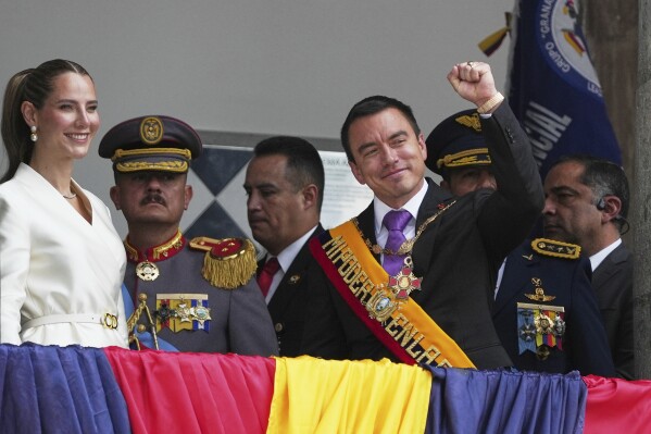 Ecuador's President Daniel Noboa and his wife, Lavinia Valbonesi, acknowledge supporters from the balcony of the presidential palace after his swearing-in ceremony for a second term in Quito, Ecuador, Saturday, May 24, 2025. (AP Photo/Carlos Noriega)