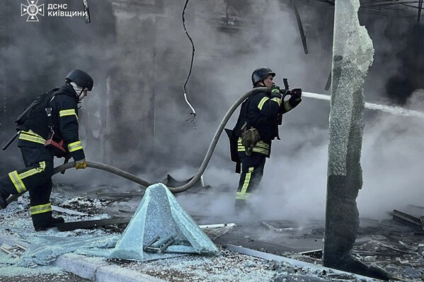 In this photo provided by the Ukrainian Emergency Service, firefighters put out the fire following Russia's drone attack in the Kyiv region, Ukraine, Sunday, May 18, 2025. (Ukrainian Emergency Service via AP)
