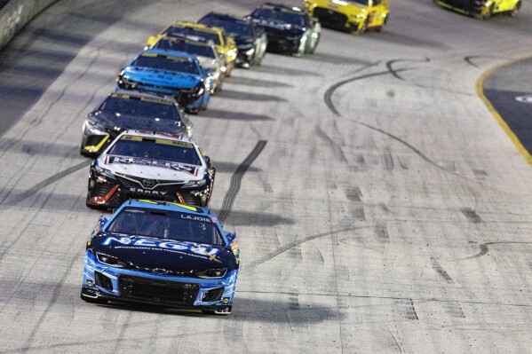 Corey LaJoie (7) leads Christopher Bell and the rest of the field during the NASCAR Cup Series auto race Saturday, Sept. 16, 2023, in Bristol, Tenn. (AP Photo/Wade Payne)