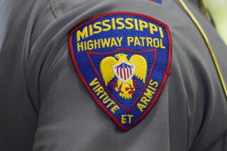 The shoulder patch of a Mississippi Highway Patrol officer is photographed during a ceremony in Jackson, Miss., May 17, 2022. An incident involving a white Mississippi Highway Patrol officer and three Black men is under investigation after a viral video showed the officer putting a handcuffed man into a chokehold and wrestling him into a ditch, Friday, Aug. 5, 2022, in McComb, Miss. (AP Photo/Rogelio V. Solis)