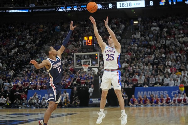 Kansas guard Nicolas Timberlake (25) shoots as Gonzaga guard Nolan Hickman (11) defends during the first half of a second-round college basketball game in the NCAA Tournament in Salt Lake City, Saturday, March 23, 2024. (AP Photo/Rick Bowmer)