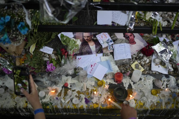 Fans of former One Direction singer Liam create a memorial outside the hotel where he was found dead after falling from a balcony in Buenos Aires, Argentina, Thursday, Oct. 17, 2024. (AP Photo/Natacha Pisarenko)