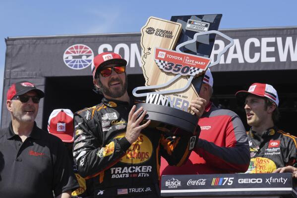 Martin Truex Jr. holds the trophy after winning a NASCAR Cup Series auto race at Sonoma Raceway, Sunday, June 11, 2023, in Sonoma, Calif. (AP Photo/Darren Yamashita)