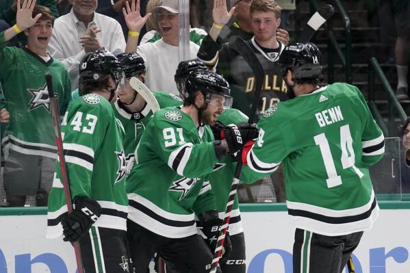 Dallas Stars' Marian Studenic (43), Tyler Seguin (91) and Jamie Benn (14) celebrate a goal scored by Seguin during the first period of the team's NHL hockey game against the New York Islanders, Tuesday, April 5, 2022, in Dallas. (AP Photo/Tony Gutierrez)