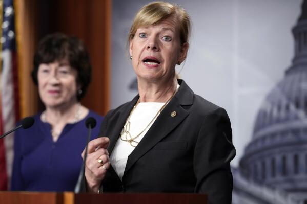 FILE - Sen. Tammy Baldwin, D-Wis., joined at left by Sen. Susan Collins, R-Maine, speaks to reporters following Senate passage of the Respect for Marriage Act, at the Capitol in Washington, Nov. 29, 2022. Baldwin is seeking a third term in battleground Wisconsin. Baldwin says in a statement released Wednesday, April 12, 2023, she'll continue to fight for the working class and families struggling with inflation and to oppose Wisconsin's abortion ban.(AP Photo/J. Scott Applewhite, File)