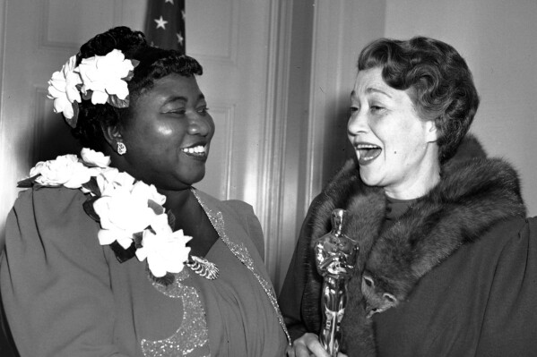 Hattie McDaniel, left, was given the Motion Picture Academy award for the best performance of an actress in a supporting role in 1939 for her work as "Mammy" in the film version of "Gone With the Wind"  on Feb. 29, 1940 in Los Angeles, Calif.  The presentation of the award was given by actress Fay Bainter, right.  (APPhoto)
