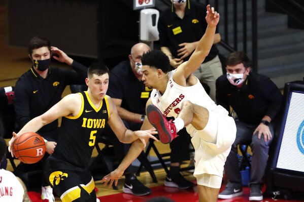Rutgers guard Geo Baker (0) defends against Iowa guard CJ Fredrick (5) during the second half of an NCAA college basketball game in Piscataway, N.J., Saturday, Jan. 2, 2021. (AP Photo/Noah K. Murray)
