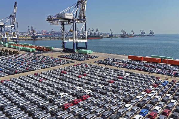 An aerial view of new cars waiting for shipment at a pier for ro-ro ships in Yantai city in eastern China's Shandong province Sunday, March 30, 2025. (Chinatopix Via AP) CHINA OUT