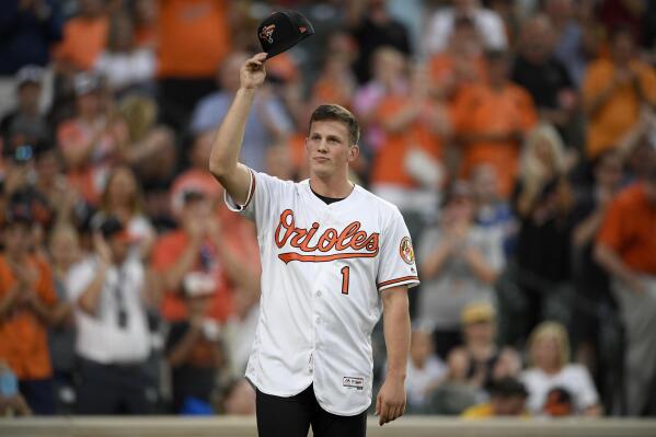 FILE - Baltimore Orioles first-round draft pick Adley Rutschman tips his cap to the crowd as he was introduced between innings of a baseball game against the San Diego Padres, Tuesday, June 25, 2019, in Baltimore. Orioles catcher Adley Rutschman, Kansas City Royals shortstop Bobby Witt Jr. and Detroit Tigers infielder Spencer Torkelson are among baseball's most intriguing rookies this summer.  (AP Photo/Nick Wass, File)