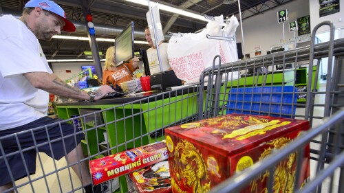 David Wright, general manager at Area 51 Fireworks in Chesterfield, N.H. helps ring out a customer on Friday, June 30, 2023. (Kristopher Radder /The Brattleboro Reformer via AP)