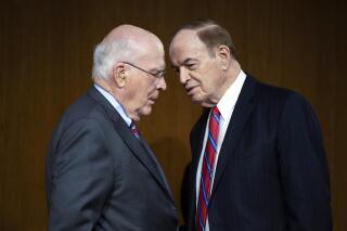 FILE - Chairman Patrick Leahy, D-Vt., left, and ranking member Sen. Richard Shelby, R-Ala., talk before a Senate Appropriations Committee hearing to examine proposed budget estimates and justification for fiscal year 2022 for the Department of Defense on Capitol Hill in Washington, on June 17, 2021. Top lawmakers say Democrats and Republicans have finally agreed on a framework for overall defense and domestic spending for this year. (Caroline Brehman/Pool via AP, File)