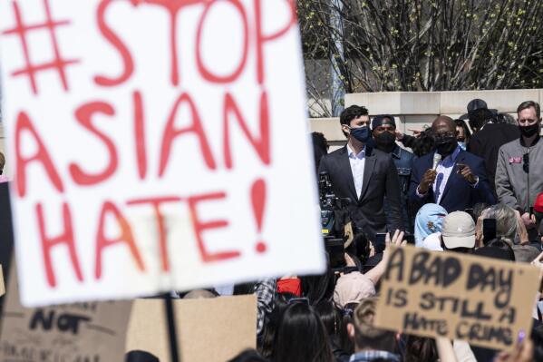 FILE - This March 20, 2021, file photo shows, U.S. Sens. Jon Ossoff, D-Ga., and Raphael Warnock, D-Ga., speaking during a "stop Asian hate" rally outside the Georgia State Capitol in Atlanta.  A national coalition of civil rights groups will release on Wednesday, July 28, 2021, a comprehensive, state-by-state review of hate crime laws in the United States. Members of the coalition say the report sets the stage for bolstering the efficacy of current law and addresses racial disparities in how the laws are enforced. (AP Photo/Ben Gray, File)