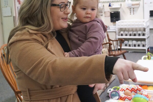 Christina Zimmerman, who teaches fourth grade at Endeavor Elementary, drops off her daughter Parker, 1, at the school's onsite daycare on Feb. 29, 2024, in Nampa, Idaho. (Carly Flandro/Idaho Education News via AP)